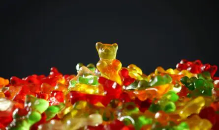 ourson en gélatine doré au centre d'un tas coloré de bonbons gélifiés