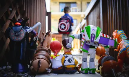 rangement jouets enfants avec figurines marvel et toy story alignées dans un couloir