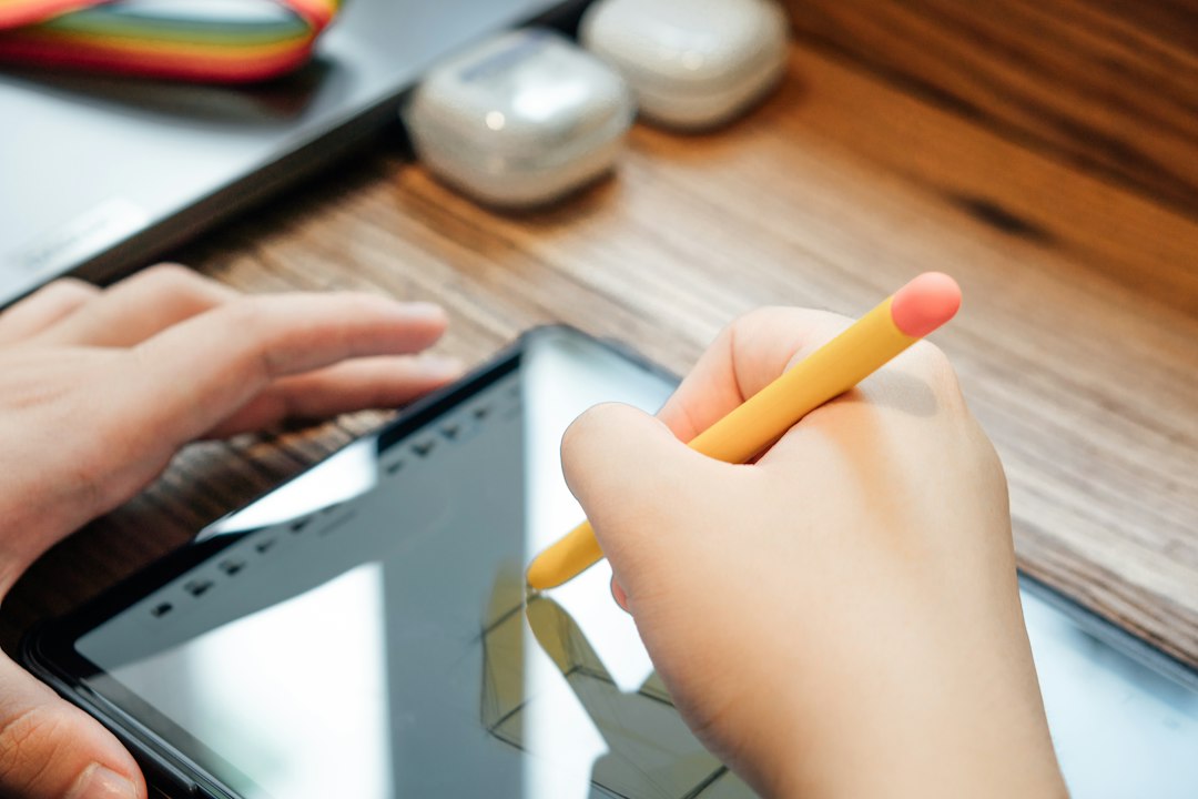 a person holding a yellow pencil